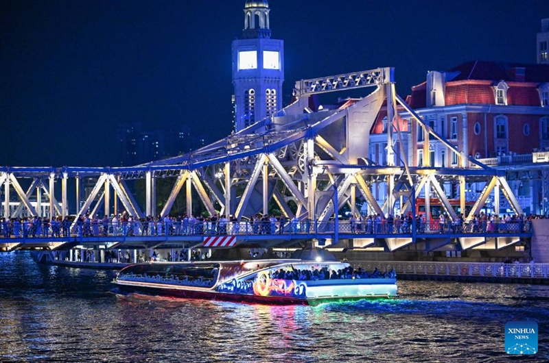 Tourists take a sightseeing boat on the Haihe River in Tianjin, north China, April 24, 2026. In recent years, Tianjin has become a popular tourist destination, as the city keeps enriching its nighttime experience by expanding tourism scenarios and diversifying business formats. (Xinhua/Sun Fanyue)