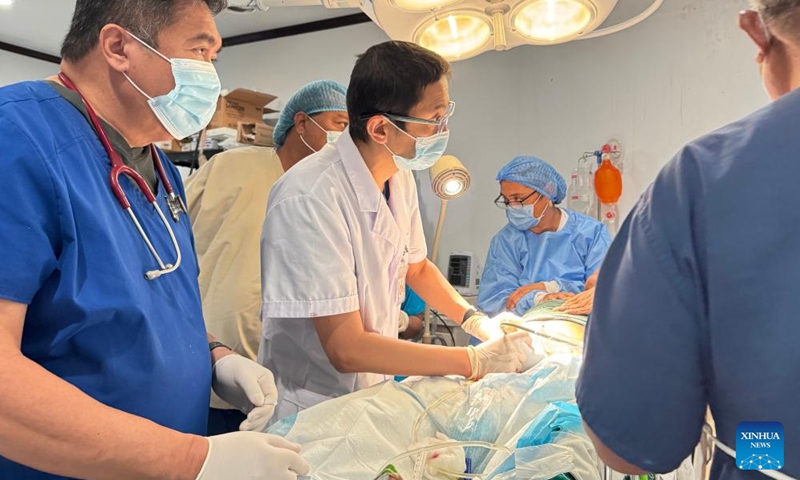 A doctor (C) from a Chinese medical team performs an ultrasound examination for a patient in Chuuk State, the Federated States of Micronesia, April 21, 2026. (Chinese medical team assisting the FSM/Handout via Xinhua)

