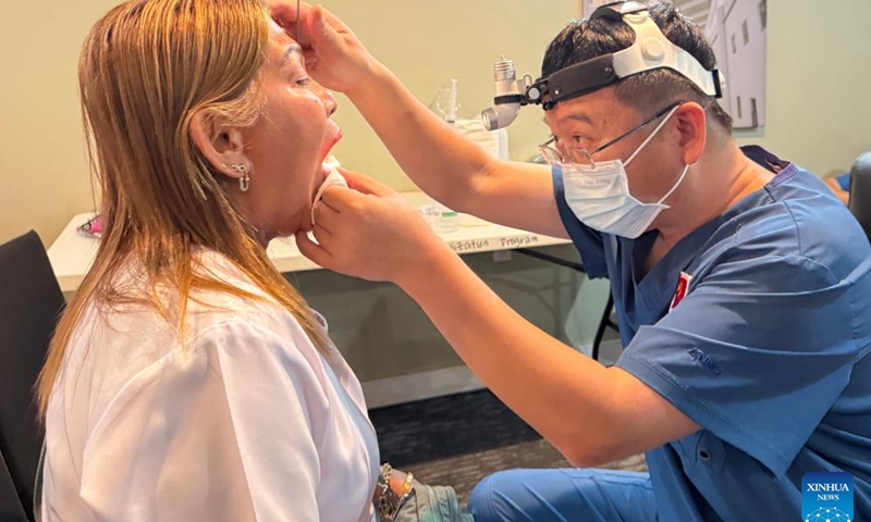 A doctor from a Chinese medical team performs an examination for a patient in Chuuk State, the Federated States of Micronesia, April 23, 2026. (Chinese medical team assisting the FSM/Handout via Xinhua)

