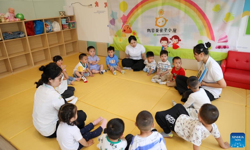 Children listen to a teacher reading stories at a nursery center in Huahong Community of Futian District in Shenzhen, south China's Guangdong Province, April 17, 2026. Shenzhen is building a 15-minute nursery circle covering a child's first 1,000 days to ease the burden of families and encourage more births.

