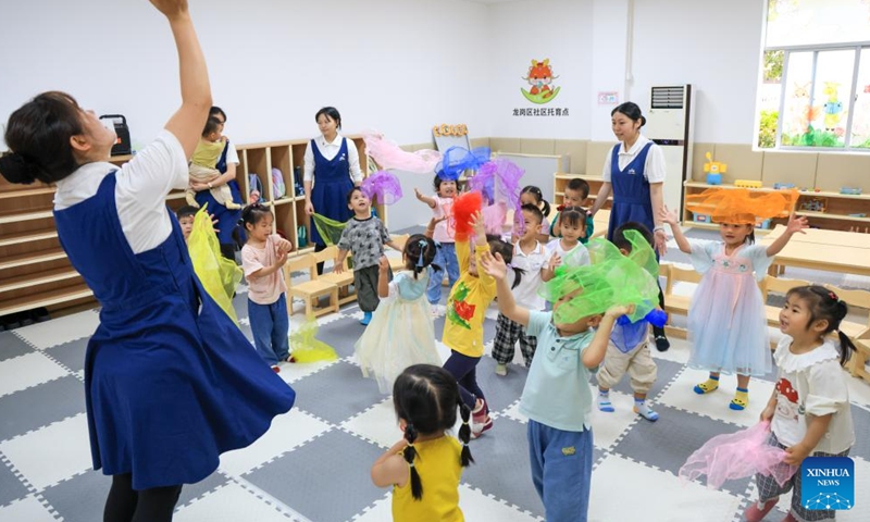 Teachers play games with children at a free nursery center in Pinghu Subdistrict of Longgang District in Shenzhen, south China's Guangdong Province, April 16, 2026. Shenzhen is building a 15-minute nursery circle covering a child's first 1,000 days to ease the burden of families and encourage more births.

