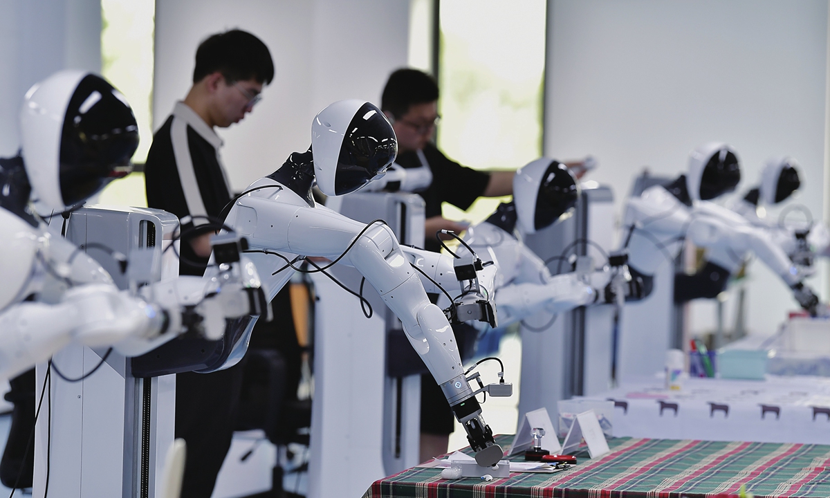 Staff members work with embodied robots in Fuzhou, East China's Fujian Province, on April 27, 2026. Photo: VCG