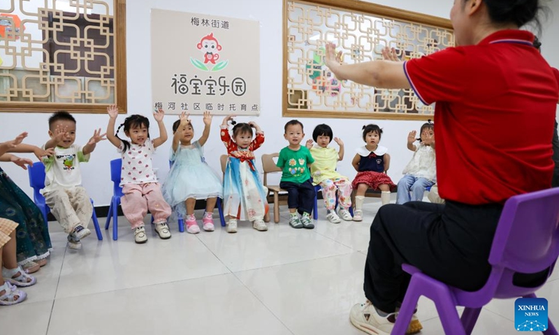 A teacher plays games with children at a nursery center in Meihe Community of Futian District in Shenzhen, south China's Guangdong Province, April 17, 2026. Shenzhen is building a 15-minute nursery circle covering a child's first 1,000 days to ease the burden of families and encourage more births.

