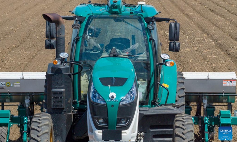A drone photo shows an unmanned intelligent agricultural machine sowing crop seeds in a field at Youyi Farm Co., Ltd. under Beidahuang Group in northeast China's Heilongjiang Province, April 28, 2026.

