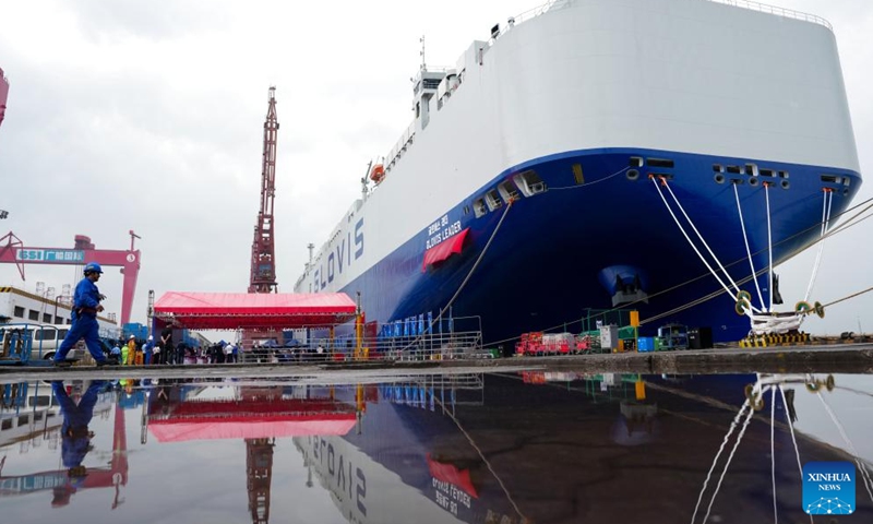 A staff member walks past car carrier Glovis Leader in Guangzhou, south China's Guangdong Province, April 28, 2026. A car carrier with a maximum capacity of 10,800 car equivalent units, described as the world's largest of its kind, was delivered Tuesday in the southern Chinese city of Guangzhou.

