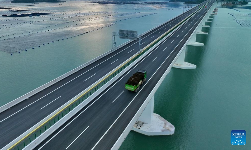 A drone photo taken on April 25, 2026 shows a truck loaded with kelp running on the Dongwuyang grand bridge along the Ningde-Shangrao Expressway in Xiapu County, Ningde City, southeast China's Fujian Province.

