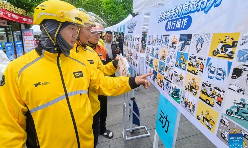 Deliverymen participate in a traffic knowledge contest in Chaoyang District, Beijing, capital of China, April 28, 2026. A volunteer activity was held here on Tuesday to offer free medicine consultations, haircuts and knowledge contests for young people in new employment sectors. (Xinhua/Li Xin)

