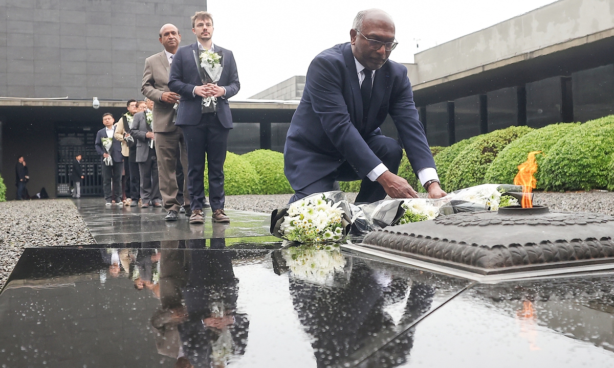 Chinese and international participants attending the exchange event marking the 80th anniversary of the opening of the Tokyo Trials lay flowers in tribute to the victims of the Nanjing Massacre in front of the Memorial Hall of the Victims in Nanjing Massacre by Japanese Invaders on April 29, 2026, in Nanjing, East China's Jiangsu Province. Photo: VCG