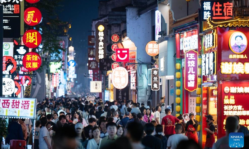 Tourists visit an old street in Changsha, central China's Hunan Province, April 25, 2026.

Changsha at night features diverse modes of business: live-streaming, band performance, period costume photography and night-market food, all contributing to the nighttime economic vitality of the city. (Xinhua/Liu Jie)