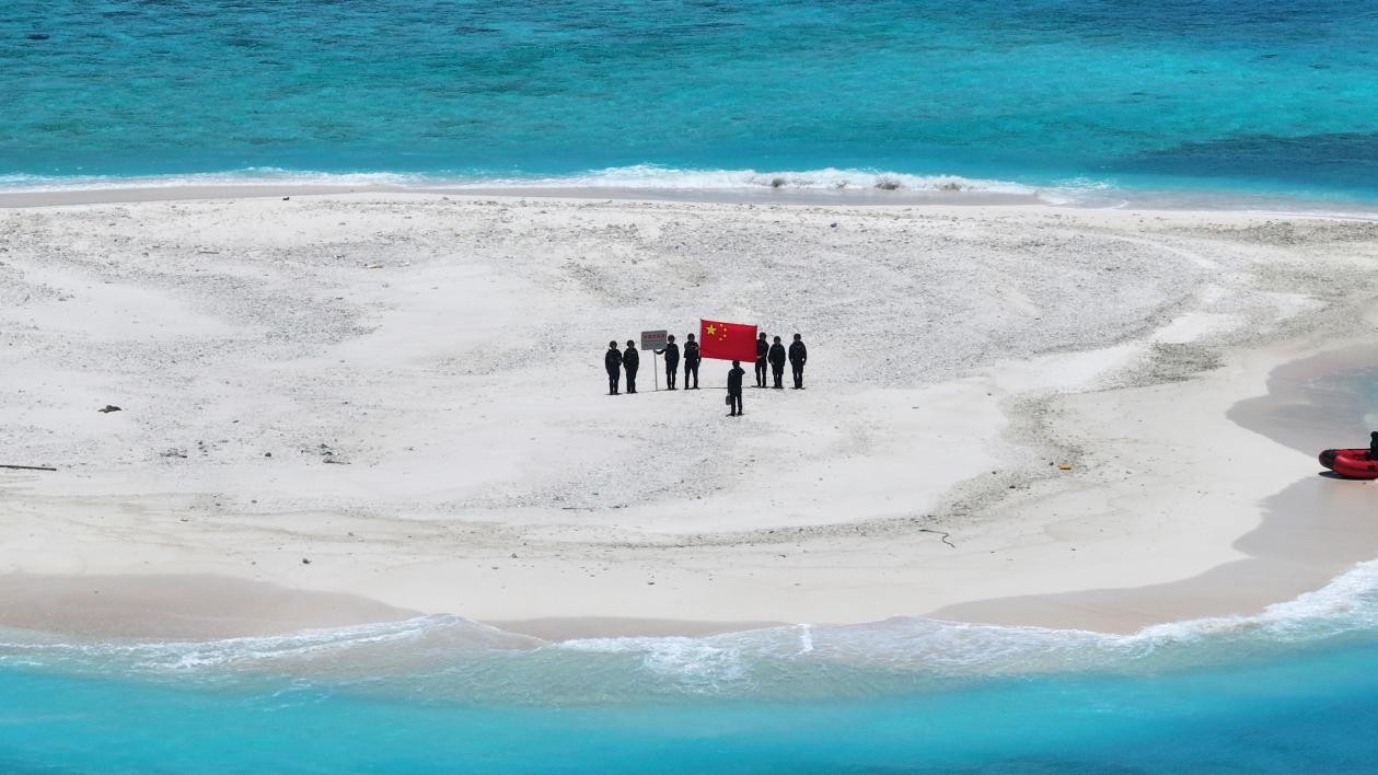 CCG officers display the Chinese national flag at Tiexian Jiao to safeguard territorial sovereignty on May 3, 2026. Photo: CCG
