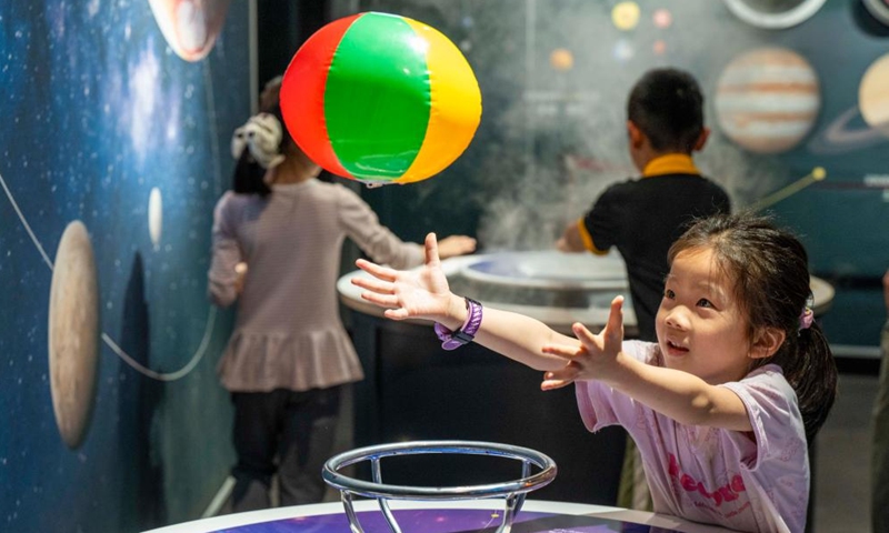 A child interacts with science popularization equipment at a science museum in Wuzhou City, south China's Guangxi Zhuang Autonomous Region, May 3, 2026.(Photo by He Huawen/Xinhua)
