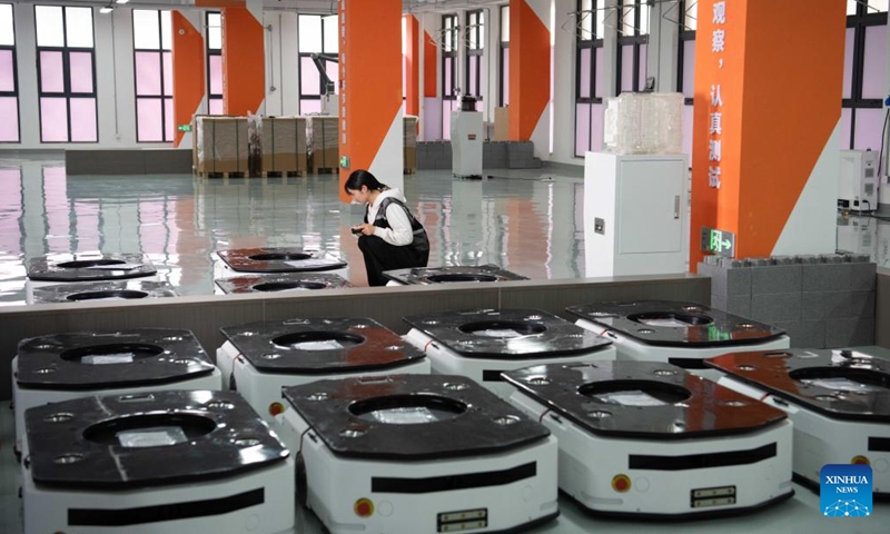 A technician checks the quality of mobile robots at Youibot Robotics Co., Ltd. in Hefei, east China's Anhui Province, April 29, 2026.(Xinhua/Zhang Duan)