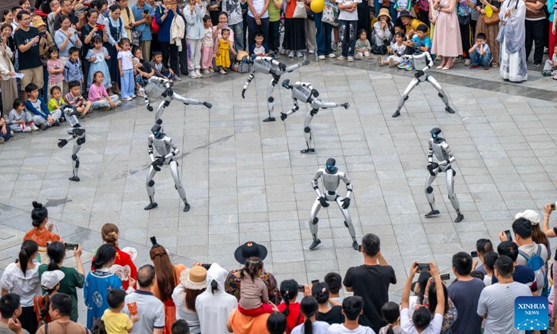 A drone photo taken on May 2, 2026 shows robots performing at a park in Wuzhou City, south China's Guangxi Zhuang Autonomous Region.(Photo by He Huawen/Xinhua)