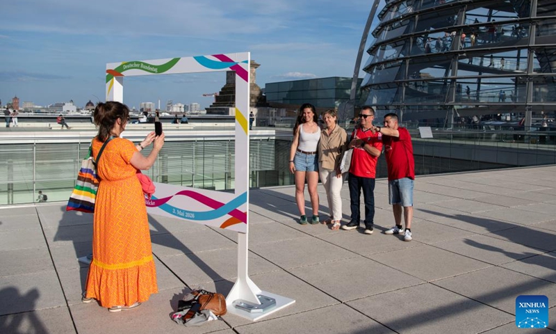 People pose for photos at the Reichstag building in Berlin, Germany, May 3, 2026. About 11,700 guests visited the Reichstag building during its open day event on Sunday. (Xinhua/Zhang Haofu)
