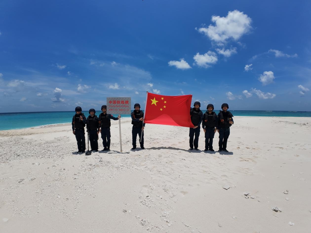 CCG officers display the Chinese national flag at Tiexian Jiao to safeguard territorial sovereignty on May 3, 2026. Photo: CCG