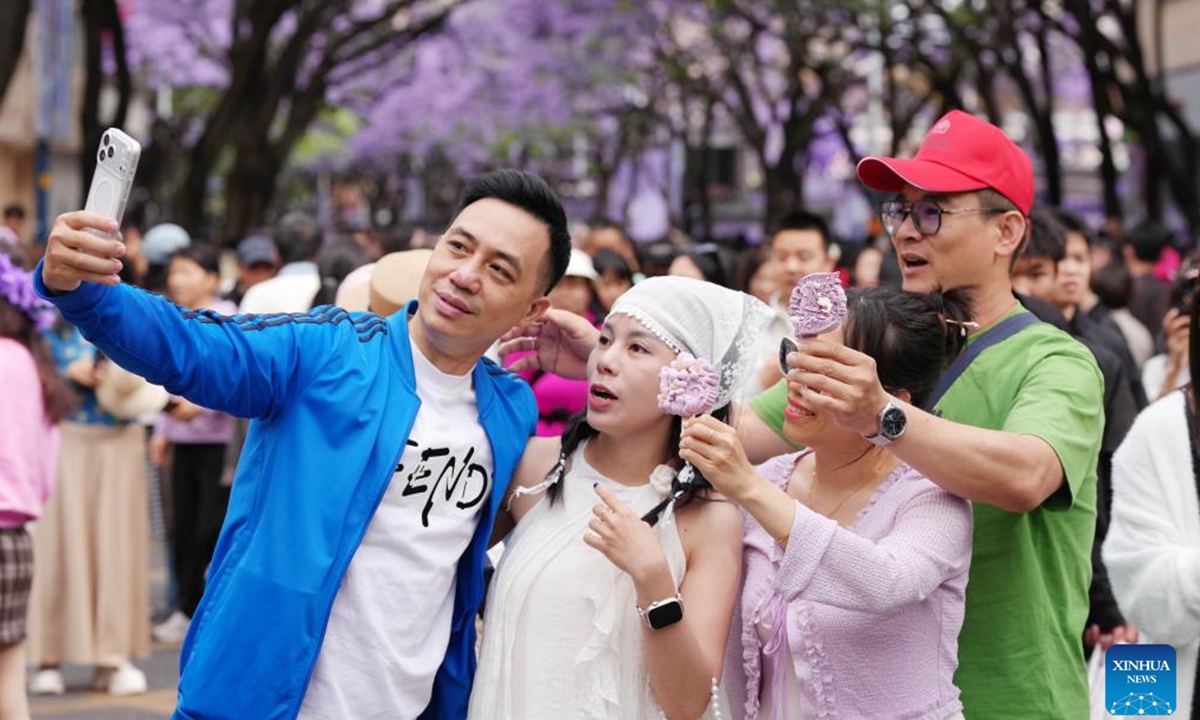 Tourists from Vietnam pose for selfies in Kunming, southwest China's Yunnan Province, May 2, 2026.
China's inbound tourism booms thanks to visa exemption policies. (Photo by Hao Yaxin/Xinhua)