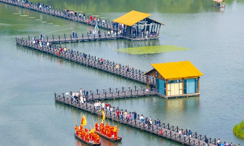 A drone photo taken on May 3, 2026 shows people visiting the Qinhu National Wetland Park in Taizhou City, east China's Jiangsu Province.(Photo by Tang Dehong/Xinhua)