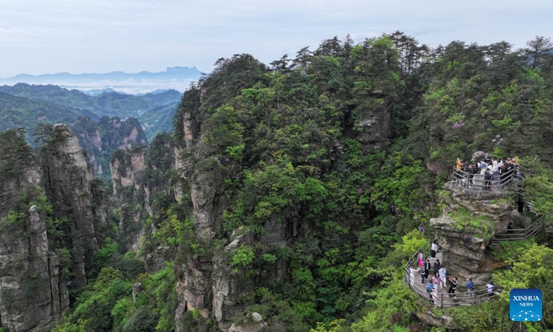 A drone photo taken on May 3, 2026 shows people visiting the Huangshizhai scenic spot in Zhangjiajie, central China's Hunan Province.(Photo by Wu Yongbing/Xinhua)