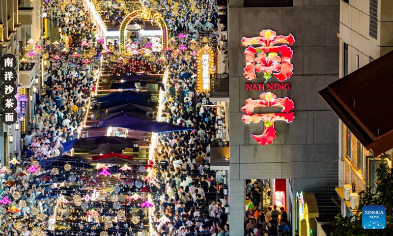 This drone photo shows tourists visiting Zhongshan Road in Nanning, south China's Guangxi Zhuang Autonomous Region, May 3, 2026. People across China stepped out to fully enjoy their leisure time during the ongoing May Day holiday. (Photo by Liu Zheng/Xinhua)