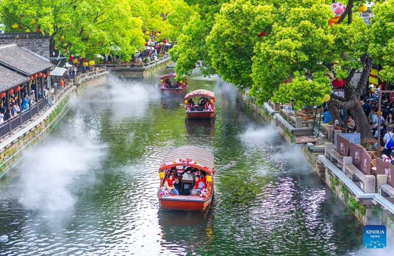 This drone photo shows tourists visiting Huishan ancient town in Wuxi City, east China's Jiangsu Province May 3, 2026. People across China stepped out to fully enjoy their leisure time during the ongoing May Day holiday. (Photo by Zhou Shegen/Xinhua)