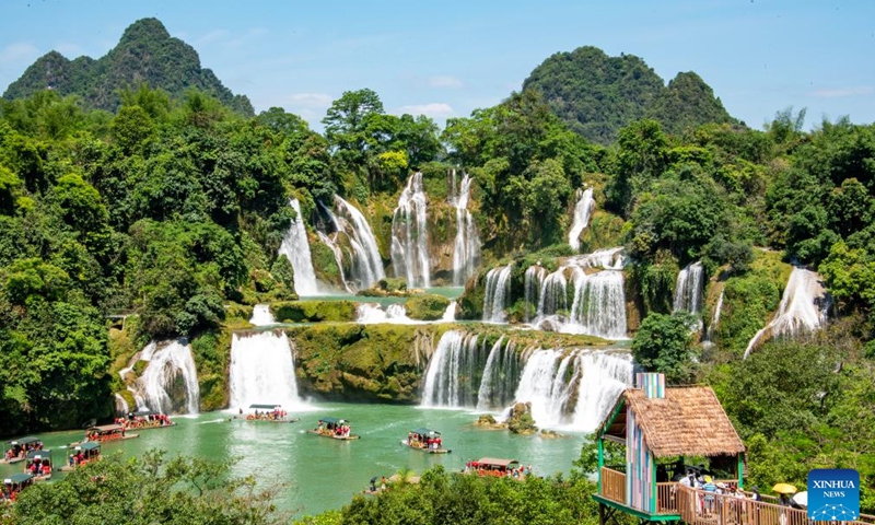 Tourists visit the Detian Waterfalls scenic area in Daxin County of Chongzuo City, south China's Guangxi Zhuang Autonomous Region, May 4, 2026. People across China stepped out to fully enjoy their leisure time during the ongoing May Day holiday. (Photo by Zhao Jingwu/Xinhua)