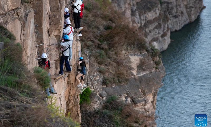 Tourists experience rock climbing during the May Day holiday in Ordos, north China's Inner Mongolia Autonomous Region, May 3, 2026. (Photo: Xinhua)