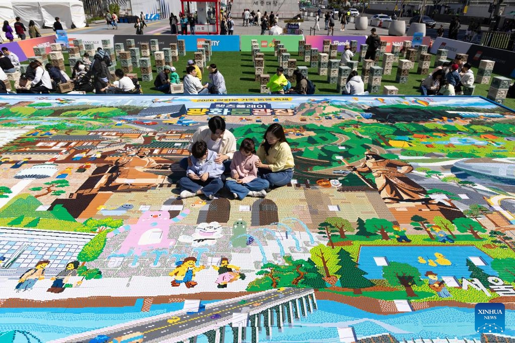 Children and parents play with building blocks at the Gwanghwamun square in Seoul, South Korea, May 5, 2026. Family activities were held here to mark the Children's Day in South Korea on Tuesday. (Photo: Xinhua)