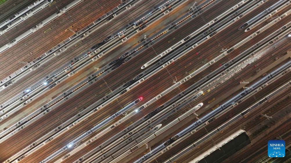 An aerial drone photo taken on May 1, 2026 shows bullet trains waiting for departure at a train depot in Zhengzhou, central China's Henan Province. China logged around 1.52 billion inter-regional passenger trips during the just-concluded five-day May Day holiday, a 3.49 percent increase over the same period last year, the Ministry of Transport said on Wednesday.