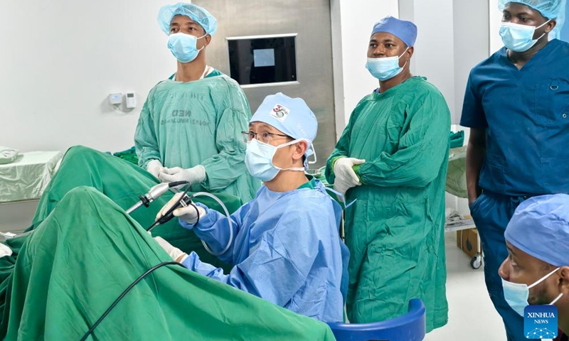 Chinese urologist Wang Kunpeng (front) performs a minimally invasive procedure using endoscopic equipment at Lumumba Hospital in Zanzibar, Tanzania, Jan. 22, 2026. (The 35th Chinese medical team to Zanzibar/Handout via Xinhua)

