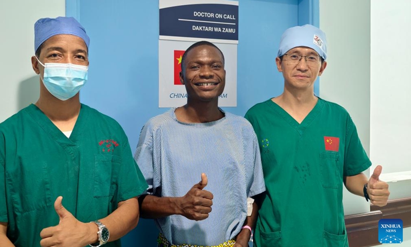 Chinese urologist Wang Kunpeng (R) and a local medical staff member (L) pose for a photo with patient Selemani Juma Selemani after a surgery at Lumumba Hospital in Zanzibar, Tanzania, Jan. 26, 2026. (The 35th Chinese medical team to Zanzibar/Handout via Xinhua)

