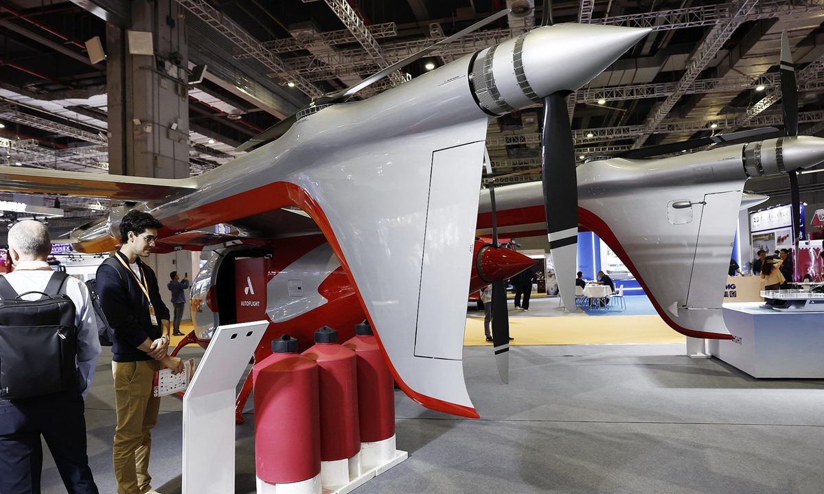 A foreign visitor learns about the fire-fighting version of an electric vertical takeoff and landing (eVTOL) model at the 5th Yangtze River Delta International Emergency Disaster Reduction and Rescue Expo at the National Exhibition and Convention Center in Shanghai, on May 7, 2026. Photo: VCG