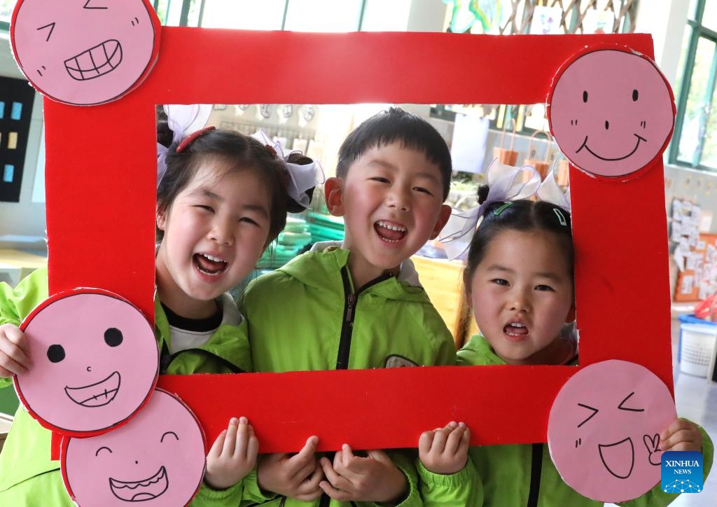 Children play a smile-themed game at a kindergarten in Suzhou City, east China's Jiangsu Province, May 7, 2026. May 8 marks the World Smile Day. (Photo by Hang Xingwei/Xinhua)

