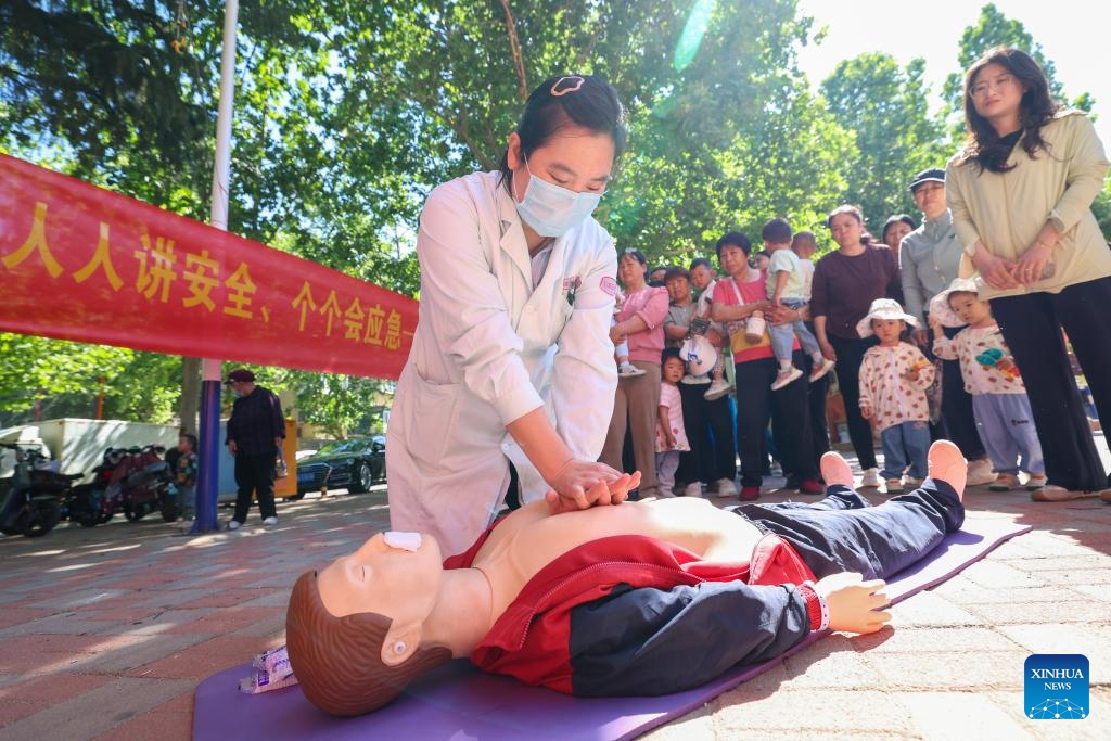 A medical worker demonstrates cardiopulmonary resuscitation (CPR) for residents in Shijiazhuang, north China's Hebei Province, May 11, 2026. A variety of activities were held across the country marking the upcoming National Disaster Prevention and Reduction Day. (Photo by Liang Zidong/Xinhua)
