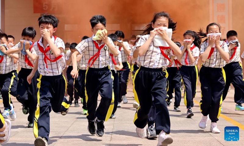 Students take part in an emergency evacuation drill at a primary school in Zaozhuang, east China's Shandong Province, May 11, 2026. A variety of activities were held across the country marking the upcoming National Disaster Prevention and Reduction Day. (Photo by Sun Zhongzhe/Xinhua)