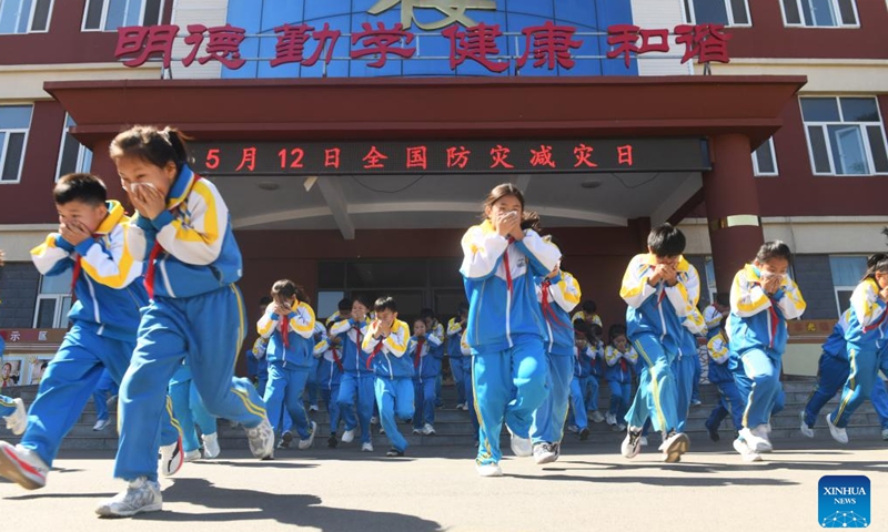 Students take part in a fire emergency evacuation drill in Xinle City, Shijiazhuang, north China's Hebei Province, May 11, 2026. A variety of activities were held across the country marking the upcoming National Disaster Prevention and Reduction Day. (Photo by Jia Minjie/Xinhua)