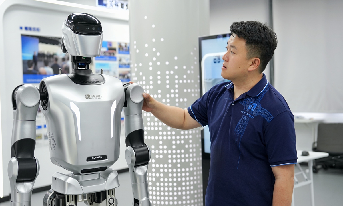 Leng Xiaokun observes the movements of his company's humanoid robot in Shenzhen, Guangdong Province. Photo: Courtesy of Leng