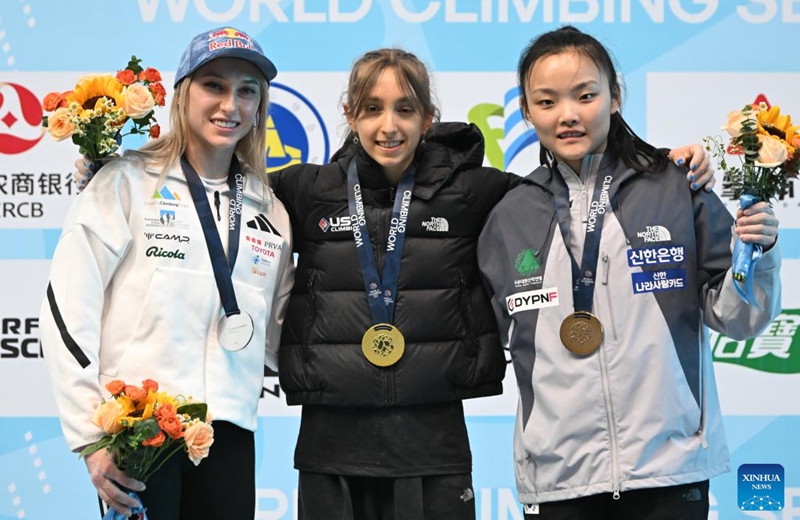 Gold medalist Annie Sanders (C) of the United States, silver medalist Janja Garnbret (L) of Slovenia and Seo Chaehyun of South Korea pose during the awarding ceremony after the women's lead final at World Climbing Series Wujiang 2026 in Suzhou, east China's Jiangsu Province, May 9, 2026. (Photo by Wang Xuzhong/Xinhua)