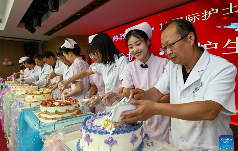 Medical staff members share cakes during International Nurses Day celebrations at Beijing Massage Hospital in Beijing, capital of China, May 9, 2026. Beijing Massage Hospital held a series of events on Saturday to celebrate the upcoming International Nurses Day, which falls on May 12. (Xinhua/Chen Shuo)