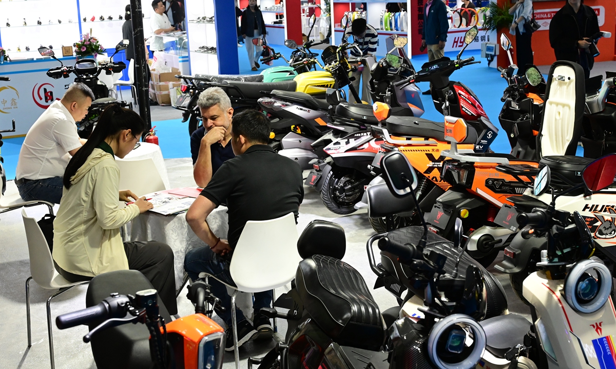 Exhibitors take part in business negotiations at the ongoing 91st China Motorcycle and Parts Trade Fair in Fuzhou, East China's Fujian Province on May 10, 2026. China has developed a complete and resilient motorcycle industry chain, and it is accelerating its transition toward electrification and intelligence, the Xinhua News Agency reported. Photo: VCG
