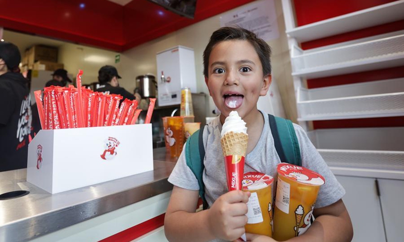 A boy eats ice cream at a Mixue Ice Cream & Tea store in Mexico City, Mexico, April 1, 2026. (Photo by Francisco Canedo/Xinhua)