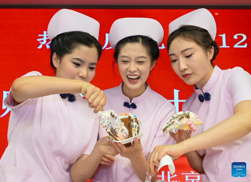 Nurses share cakes during International Nurses Day celebrations at Beijing Massage Hospital in Beijing, capital of China, May 9, 2026. Beijing Massage Hospital held a series of events on Saturday to celebrate the upcoming International Nurses Day, which falls on May 12. (Xinhua/Chen Shuo)