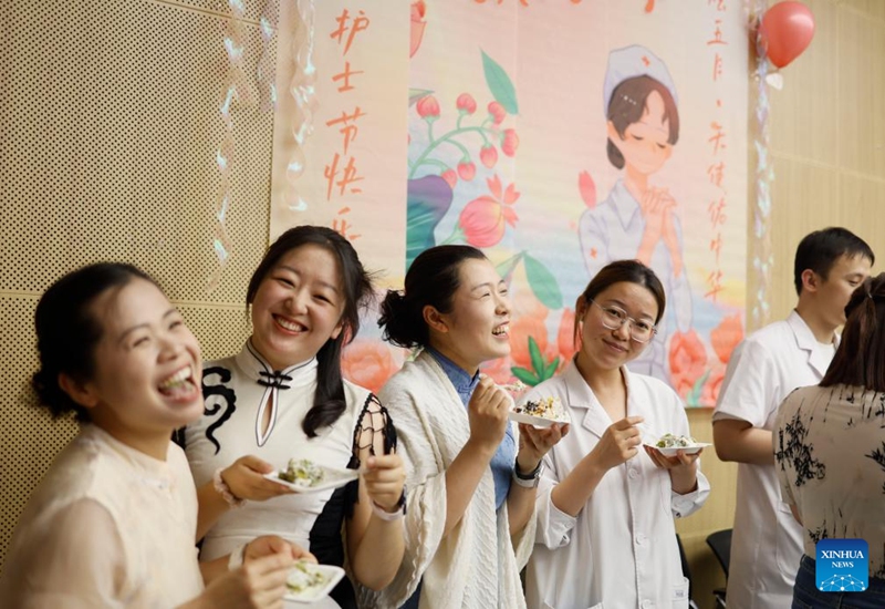 Medical staff members enjoy cakes during International Nurses Day celebrations at Beijing Massage Hospital in Beijing, capital of China, May 9, 2026. Beijing Massage Hospital held a series of events on Saturday to celebrate the upcoming International Nurses Day, which falls on May 12. (Xinhua/Cai Yang)