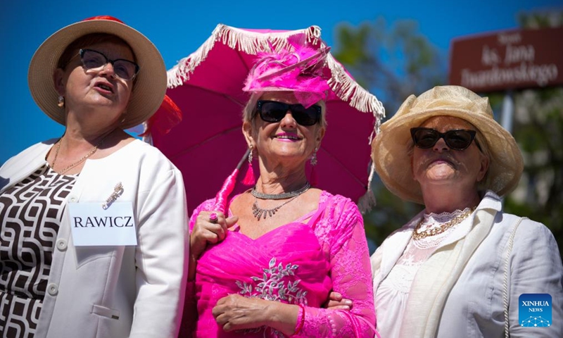 People wearing various hats take part in the Hat Walk Warsaw event in Warsaw, Poland, May 10, 2026. Participants of the Hat Walk Warsaw event walked along main streets in the city's Old Town to showcase creativity and personal style. (Photo: Xinhua)