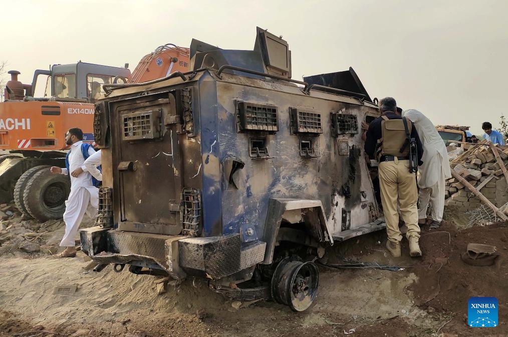 A destroyed police armored vehicle is seen at the site of a suicide attack in Bannu district, Khyber Pakhtunkhwa province, Pakistan, May 10, 2026. At least 12 police personnel were killed and several others injured after a suicide bomber rammed an explosive-laden vehicle into a police installation in Pakistan's northwestern Khyber Pakhtunkhwa province, official sources said on Sunday. (Photo: Xinhua)