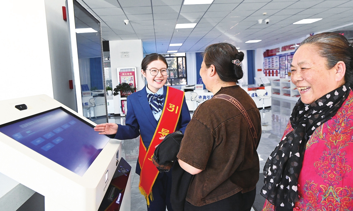 A Party member assists residents in handling procedures efficiently at the government service center in Mongolian autonomous county of Hoboksar in Northwest China's Xinjiang Uygur Autonomous Region, on April 9, 2026. Photo: VCG