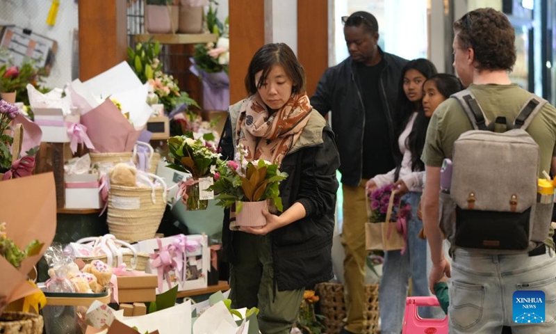 A customer selects Mother's Day flowers in Canberra, Australia, on May 10, 2026. (Photo: Xinhua)