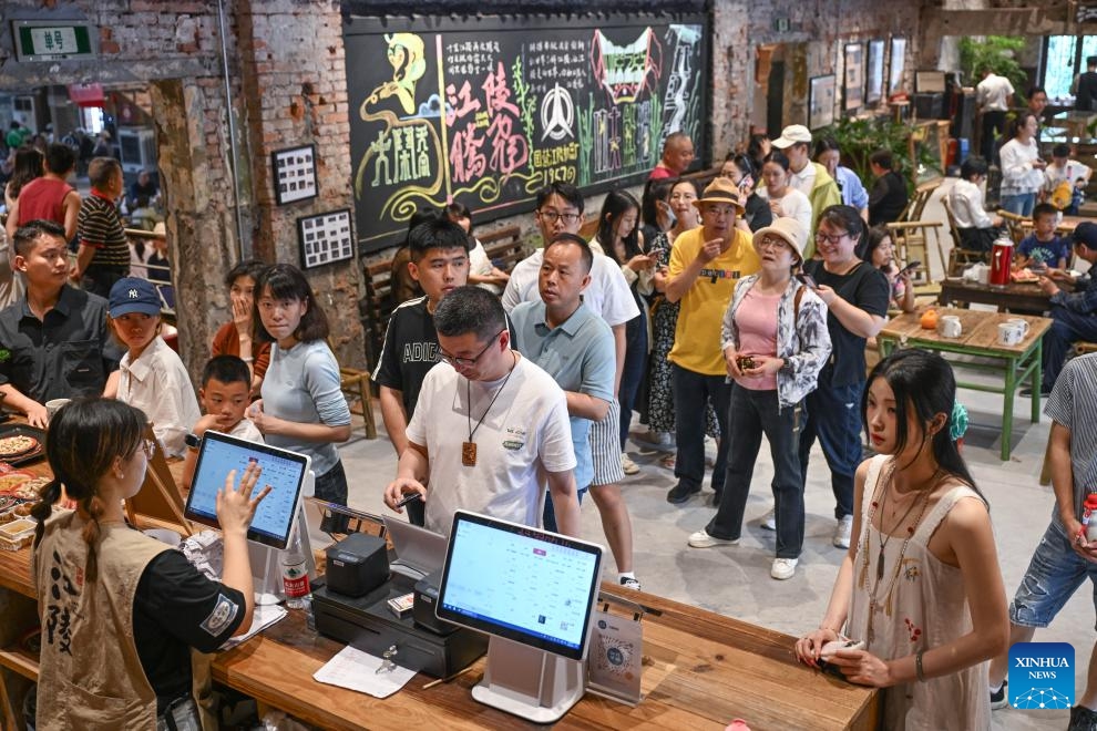 People line up to buy tea drinks at a tea house in Chongqing, southwest China, May 10, 2026. Originally built in the 1950s as a workers' cinema of a local machinery factory in Chongqing, the building has been renovated into a public tea house called Jiangling tea house now, integrating dining, leisure, and cultural creativity, favored by both local citizens and tourists. (Photo: Xinhua)