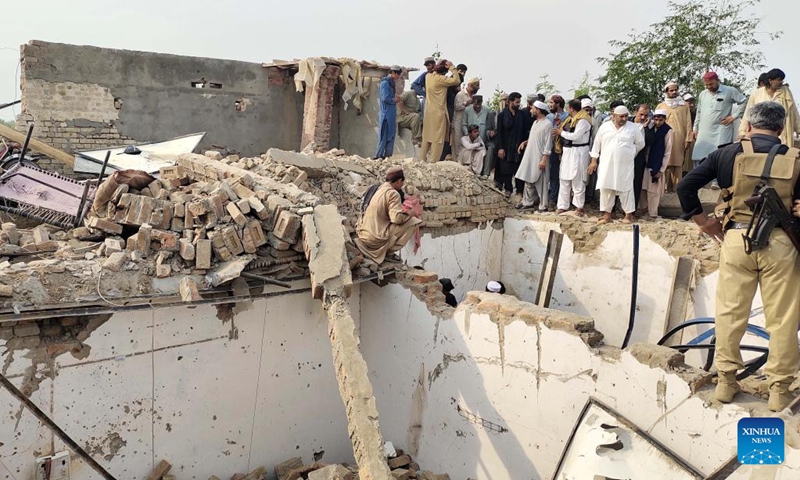 People gather at the site of a suicide attack in Bannu district, Khyber Pakhtunkhwa province, Pakistan, May 10, 2026. At least 12 police personnel were killed and several others injured after a suicide bomber rammed an explosive-laden vehicle into a police installation in Pakistan's northwestern Khyber Pakhtunkhwa province, official sources said on Sunday. (Photo: Xinhua)