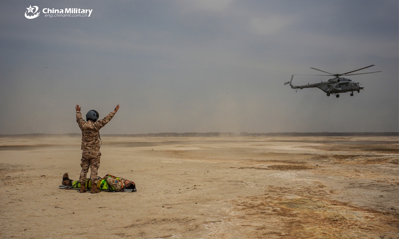 An air crewman assigned to a search and rescue aviation brigade of the air force under the Chinese PLA Northern Theater Command guides a Mi-171Sh helicopter close in during a CSAR training exercise. (Photo: eng.chinamil.com.cn)