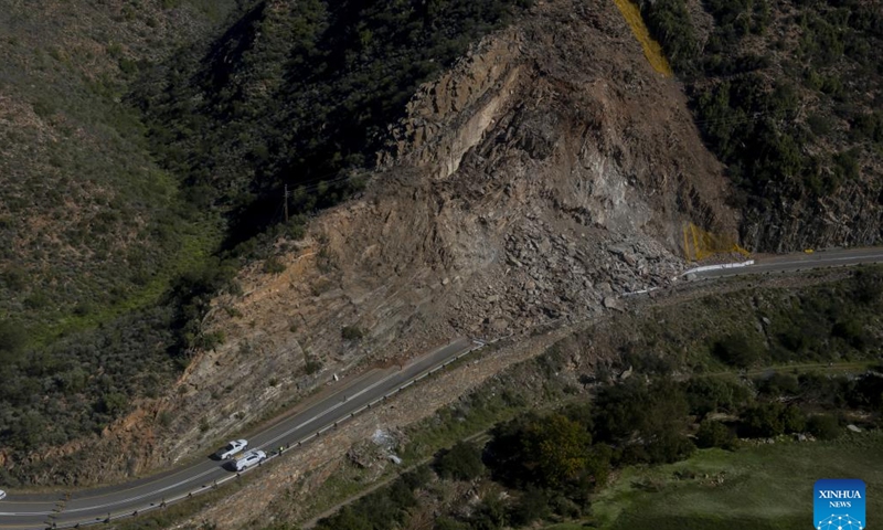 This aerial photo taken on May 9, 2026 shows a road cut off by flooding in Garden Route District Municipality, Western Cape, South Africa. The South African government has officially classified the devastating severe weather affecting multiple provinces across the country as a national disaster. In a statement issued on Saturday night, the Department of Cooperative Governance (DCoG) said that since May 4, heavy rainfall, flooding, thunderstorms, damaging winds and snowfall have caused deaths, infrastructure damage and disruptions to essential services in the Western Cape, Eastern Cape, Northern Cape, North West, Free State and Mpumalanga provinces. (Photo: Xinhua)